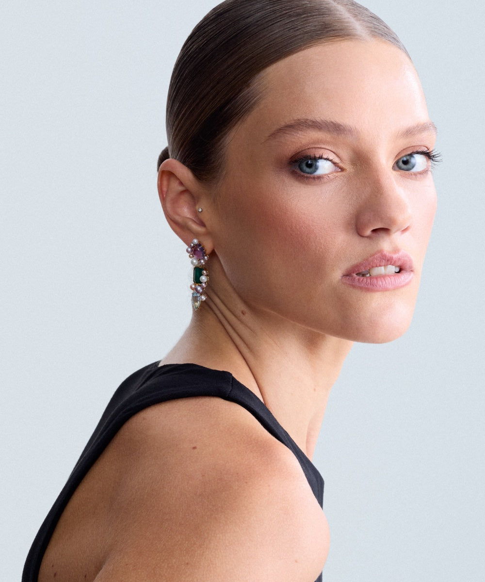 Fierce Pearls Artemisia Cascade Mini Earrings in 18K gold-plated finish worn by a model, featuring 3 gemstones, green agate, sky blue topaz, amethyst gemstones, and multicolored freshwater pearls in a sculptural statement design.