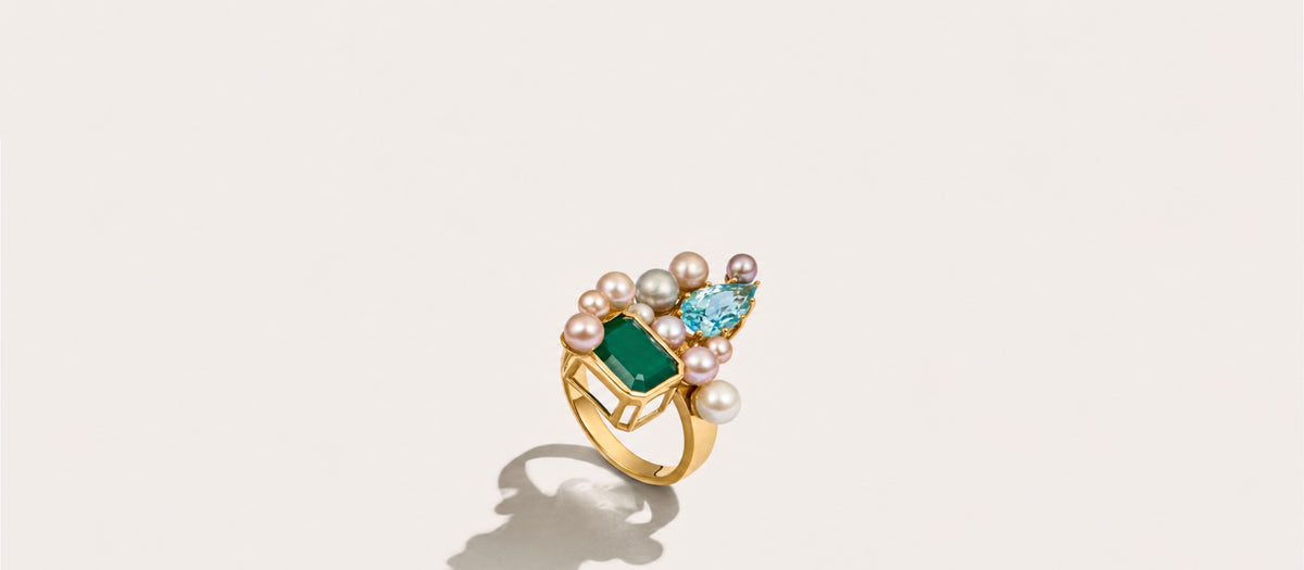 Fierce Pearls Artemisia Collector Ring in 18K gold-plated finish featuring a deep green agate gemstone, a sparkling sky blue topaz gemstone, and a cluster of multicolored freshwater pearls.