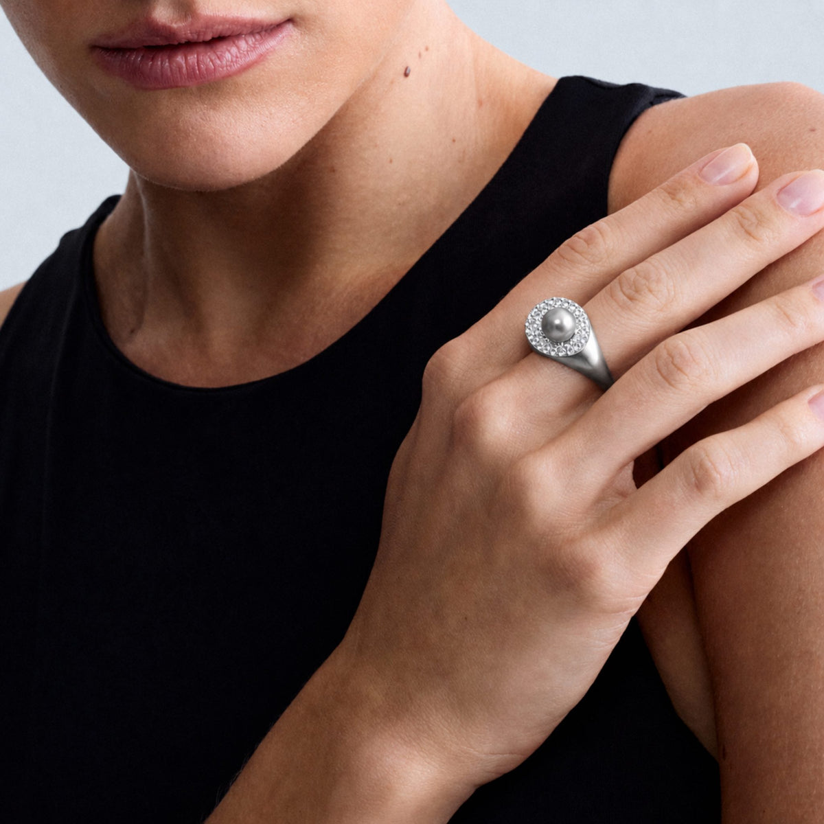 Close-up of a model wearing the Audrey Étoile Ring in sterling silver featuring a silver freshwater cultured pearl and natural white zircon pavé.