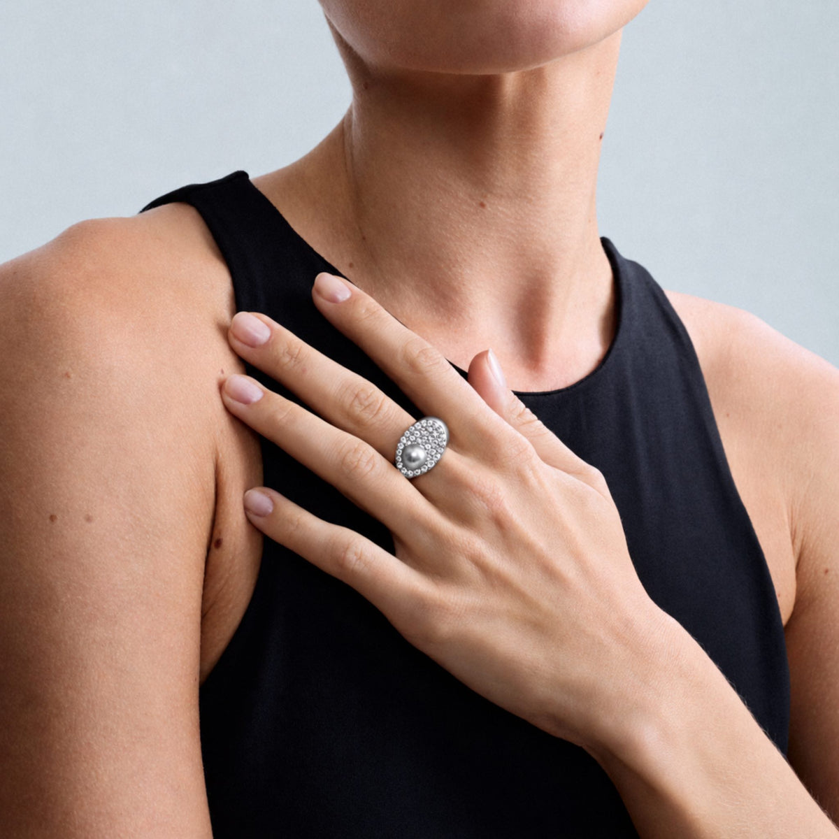 Editorial close-up of a model wearing the Audrey Étoile Ring in sterling silver featuring a silver freshwater cultured pearl and natural white zircon pavé.