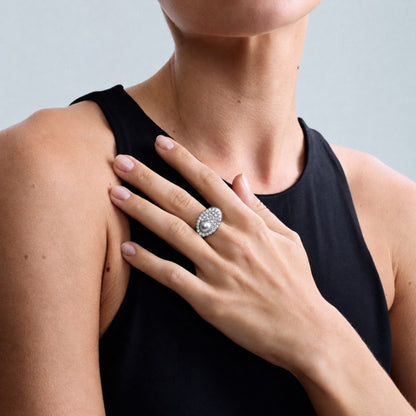 Editorial close-up of a model wearing the Audrey Étoile Ring in sterling silver featuring a silver freshwater cultured pearl and natural white zircon pavé.