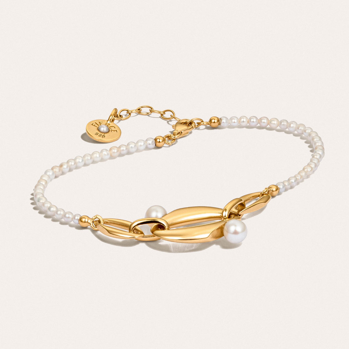Angled view of the Audrey Swan Bracelet, showcasing white freshwater cultured pearls in 18K gold-plated sterling silver.
