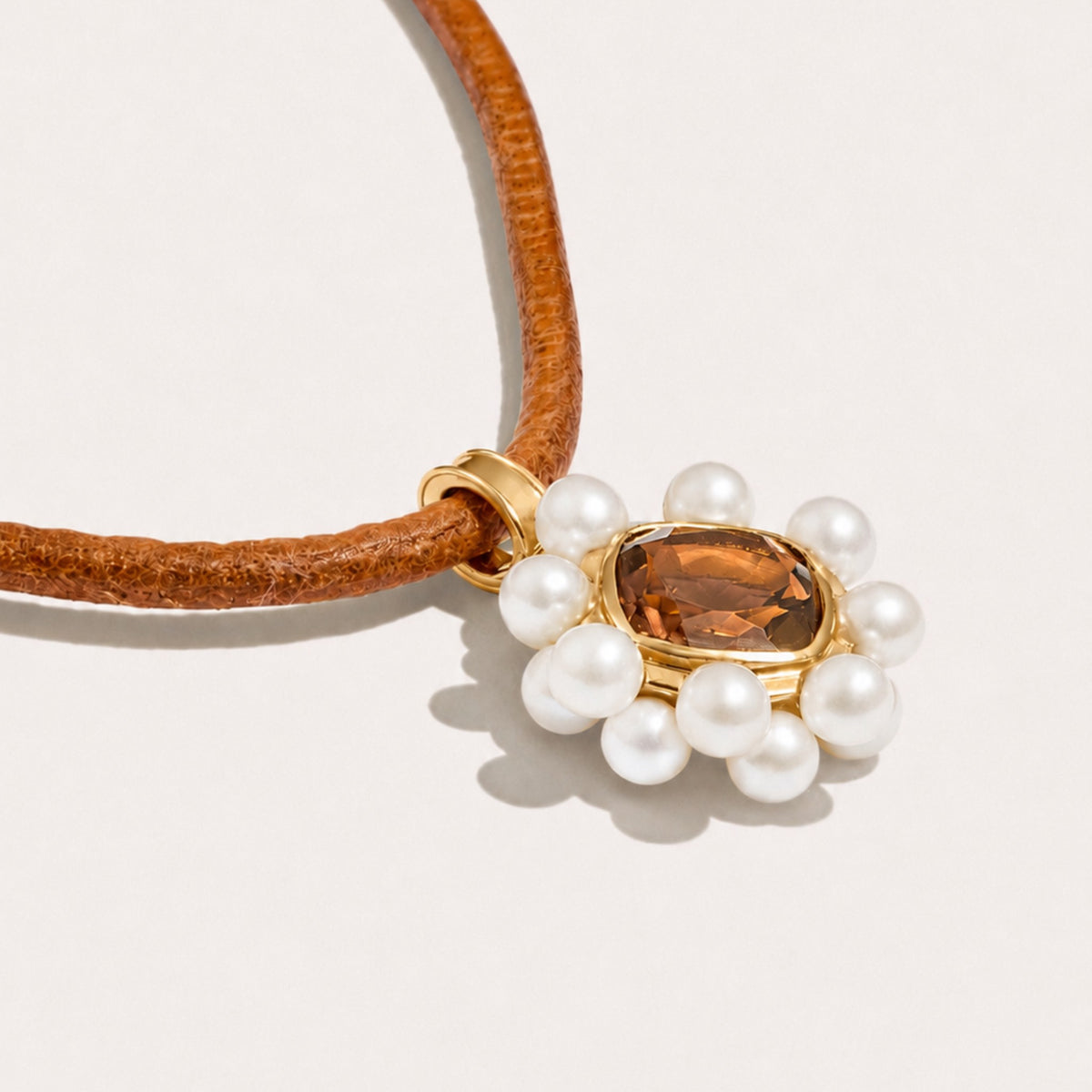 Angled view of the Carmen Soul Pendant, showcasing white freshwater cultured pearls, genuine smoky quartz and 18K gold-plated sterling silver.