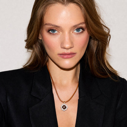 Close-up of a model wearing the Carmen Soul Pendant in 18K gold-plated sterling silver featuring white freshwater cultured pearls and genuine smoky quartz.
