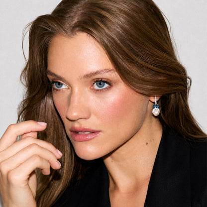 Model wearing the Xéna Spike Earrings in sterling silver featuring white freshwater cultured pearls, genuine London Blue Topaz and natural white zircon pavé.